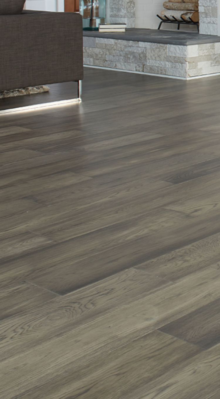 grey hardwood flooring in living room with fireplace